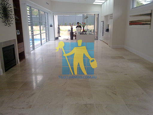 Gold Coast travertine tiles in large empty living room large tiles after cleaning