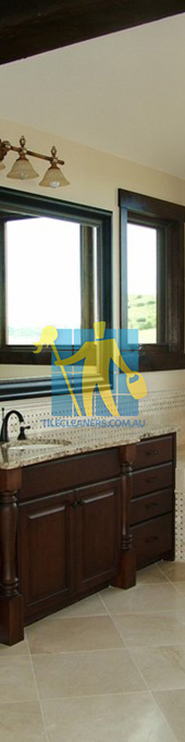 traditional bathroom with shiny stone tiles and mosaic bath tub sides wooden cabinets Adelaide Airport/Salisbury