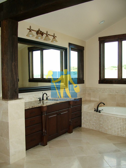 traditional bathroom with shiny stone tiles and mosaic bath tub sides wooden cabinets Pasadena
