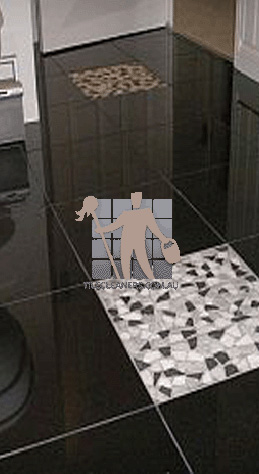 polished granite tile floor in bathroom black with one white tile Sydney Olympic Park/Western Sydney